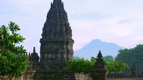 Prambanan Hindu temple complex against active volcano Mount Merapi. Indonesia Stock Footage 74399231