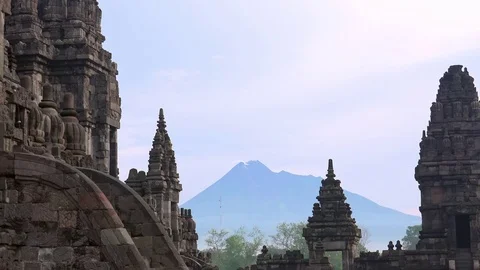 Prambanan Hindu temple complex against active volcano Mount Merapi. Indonesia Stock-Footage 74399522
