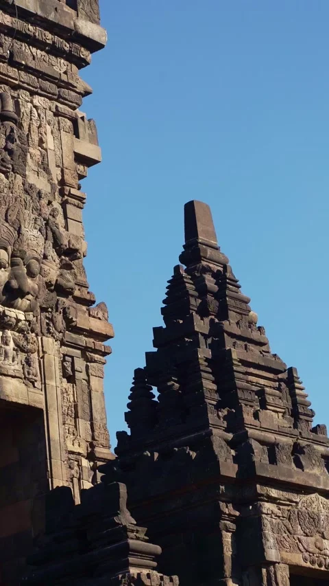Prambanan Temple spire rises between shadowed stone structures in a dramati.. Stock Footage 341547393