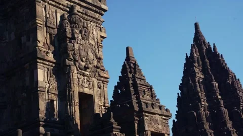 Prambanan Temple spires rise dramatically between carved stone walls beneat.. Stock Footage 341544013