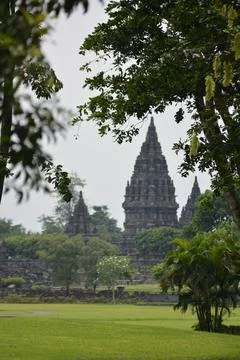 Prambanan Temples Vertical Framed By Trees Yogyakarta Indonesia February 21.. Stock Photos