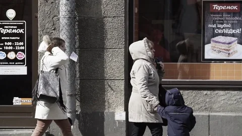 Prankster in t rex costume in crowd of people walking on city sidewalk Stock Footage 84928601