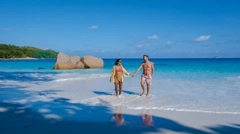 Praslin Seychelles tropical island with withe beaches and palm trees, couple men Stock Photos
