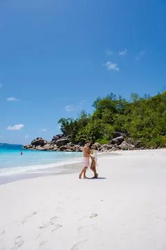 Praslin Seychelles tropical island with withe beaches and palm trees, couple men Stock Photos