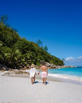 Praslin Seychelles tropical island with withe beaches and palm trees, couple men Stock Photos