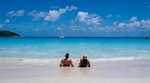 Praslin Seychelles tropical island with withe beaches and palm trees, couple men Stock Photos