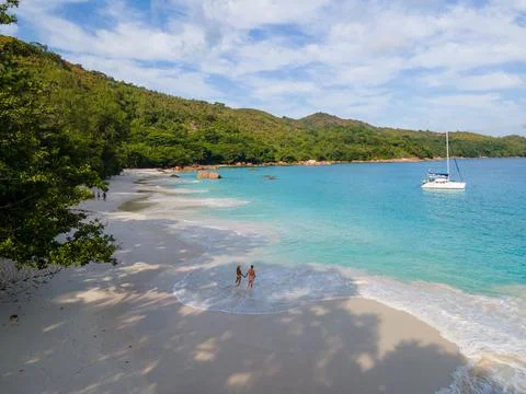 Praslin Seychelles tropical island with withe beaches and palm trees, couple men Stock Photos