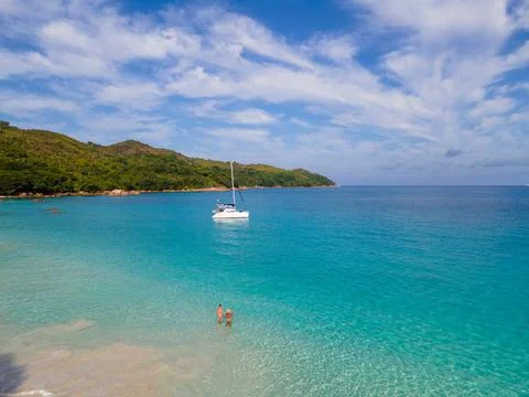 Praslin Seychelles tropical island with withe beaches and palm trees, couple men Stock Photos