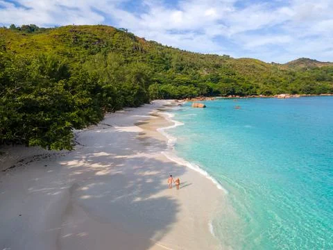Praslin Seychelles tropical island with withe beaches and palm trees, couple men Stock Photos