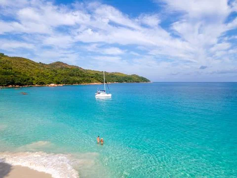 Praslin Seychelles tropical island with withe beaches and palm trees, couple men Stock Photos