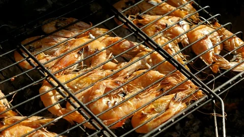 Prawn baking and roasting on barbecue grill. Shrimp grilled over charcoal. 4K Stock Footage 119814533