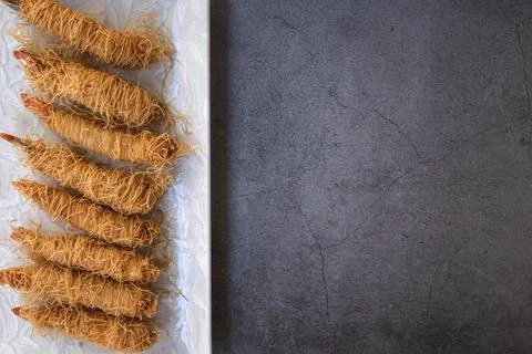 Prawn dish wrapped in small crispy potato spirals with space for text Stock Photos