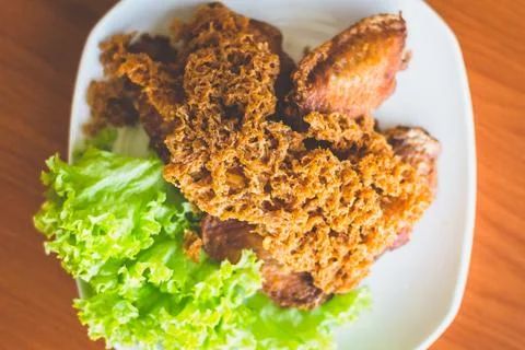 Prawn paste crispy fried chicken served on lettuce leaf and white plate Stock Photos