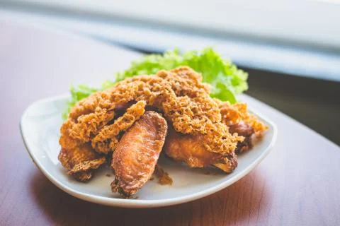 Prawn paste crispy fried chicken served on lettuce leaf and white plate Stock Photos