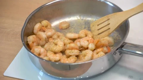Prawns are fried in a frying pan Stock Footage 148553009