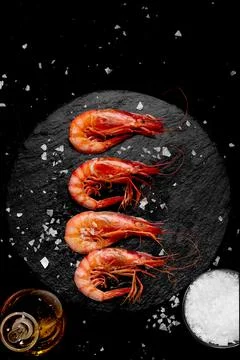 Prawns cooked with salt and oil on a stone plate vertical Stock Photos
