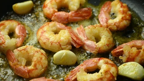 Prawns fried in a pan with garlic Stock Footage 128043960