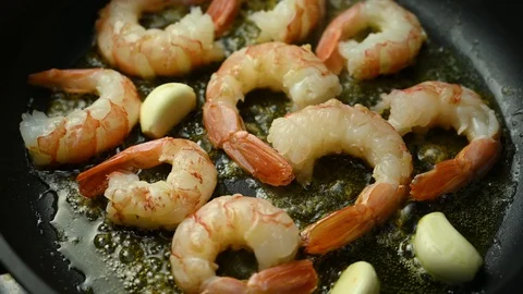 Prawns fried in a pan with garlic Stock Footage 128044108