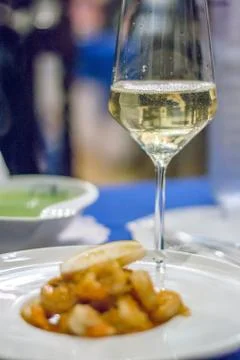 Prawns sauteed with Garlic and served with a wedge of lemon in a white china  Stock Photos
