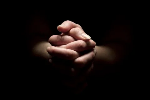 Pray with folded hands Stock Photos