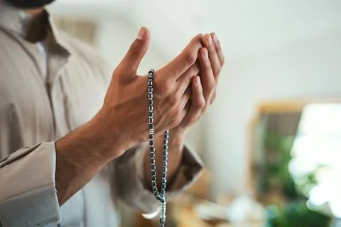 Pray as you can, not as you cant. a unrecognizable muslim man praying in the Stock Photos