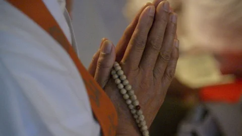 Prayer beads in hands at Buddhist service Stock Footage 86759000