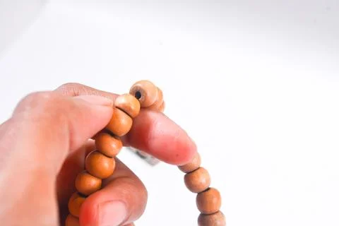 Prayer beads in shape of crescent for Ramadan on grey background Stock Photos