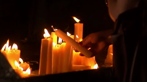 Prayer candles being placed in slow motion Stock Footage 40105283
