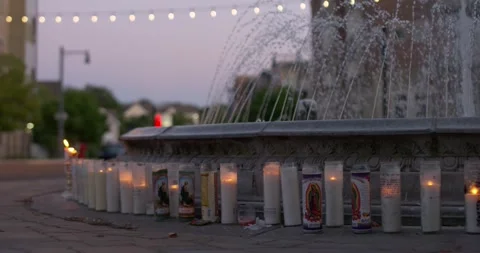 Prayer candles placed next to a water fountain Vídeos de archivo 159085772
