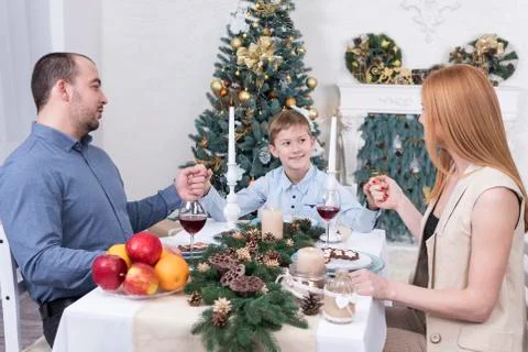 Prayer at the christmas table Stock Photos