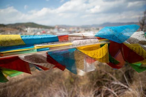 Prayer flags blowing in the wind in China Stock Photos