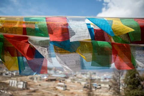 Prayer flags blowing in the wind in China Stock Photos