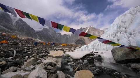 Prayer flags blowing on wind, Himalaya mountains,icy stream. Everest base camp Stock Footage 70215899