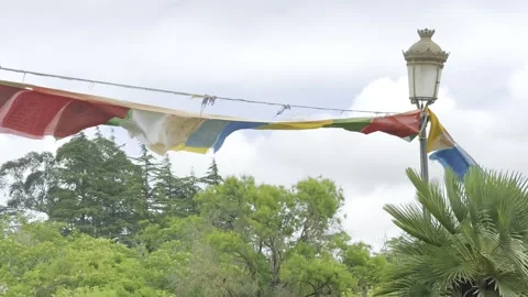 Prayer flags flutter in the wind at a buddhist monastery in garraf spain Stock Footage 311369746