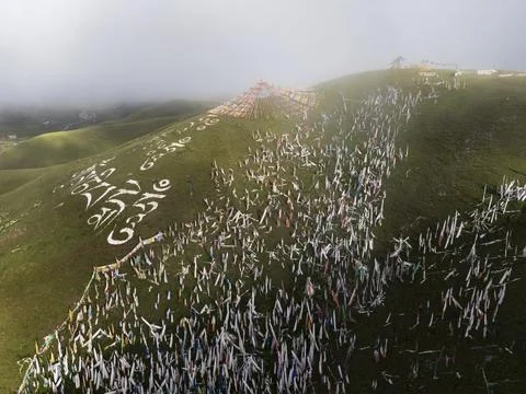 Prayer Flags on the Side of a Hil on a Misty Morning..Tagong, Sichuan Provi.. Stock Photos
