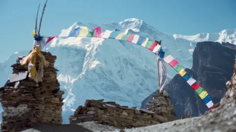 Prayer Flags in Snowcapped Mountains in Nepal, Colorful Tibetan Buddhist Prayer Stock Footage 294613767
