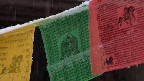 Prayer flags swaying under the snow . Shallow depth of field. Stock Footage 104656895