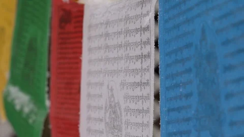Prayer flags swaying under the snow . Shallow depth of field. Stock Footage 104656967