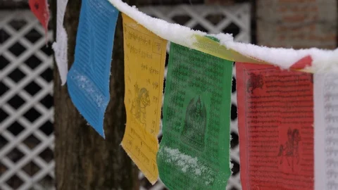 Prayer flags swaying under the snow . Shallow depth of field. Stock Footage 104656970