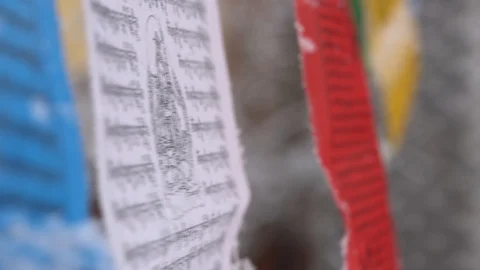 Prayer flags swaying under the snow . Shallow depth of field. Stock Footage 104658299