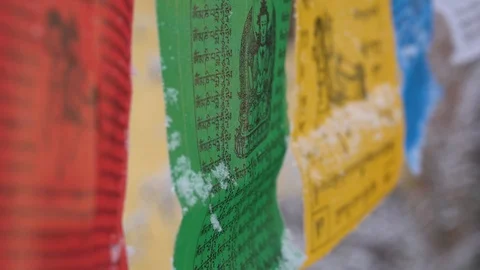 Prayer flags swaying under the snow . Shallow depth of field. Stock Footage 104658373