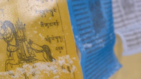 Prayer flags swaying under the snow . Shallow depth of field. Stock Footage 104659640