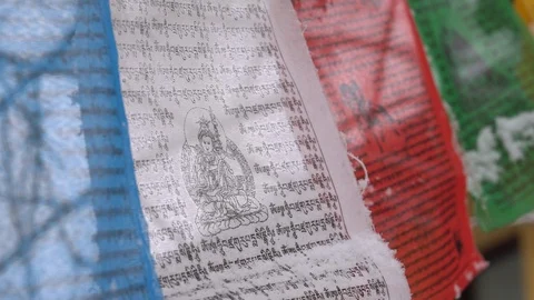 Prayer flags swaying under the snow . Shallow depth of field. Stock Footage 104660558