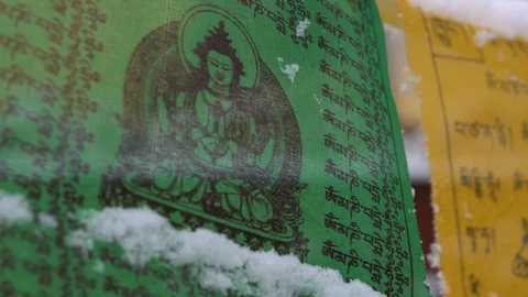 Prayer flags swaying under the snow . Shallow depth of field. Stock Footage 104660600