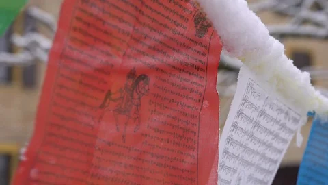 Prayer flags swaying under the snow . Shallow depth of field. Stock Footage 104661502