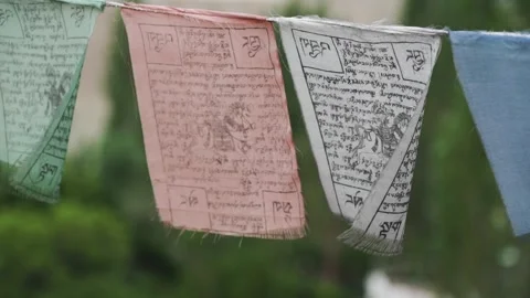 Prayer flags with Tibetan script and symbols gently sway in the wind Video stock 309330629