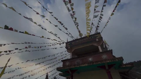 Prayer flags wave above historic buddhist monastery in himalayan mountains .. Stock Footage 337524474