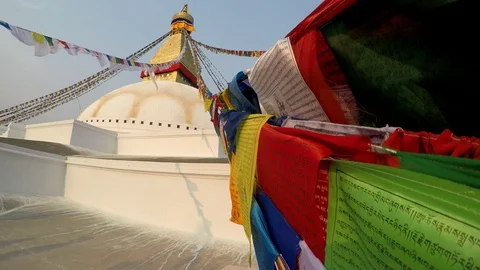 Prayer flags waves in the wind near Boudhanath Stupa in Kathmandu Stock Footage 125388702