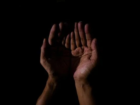 Prayer hands on dark background Stock Photos
