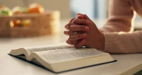 Prayer hands, reading and bible study in home, faith and scripture review for Video stock 312876381